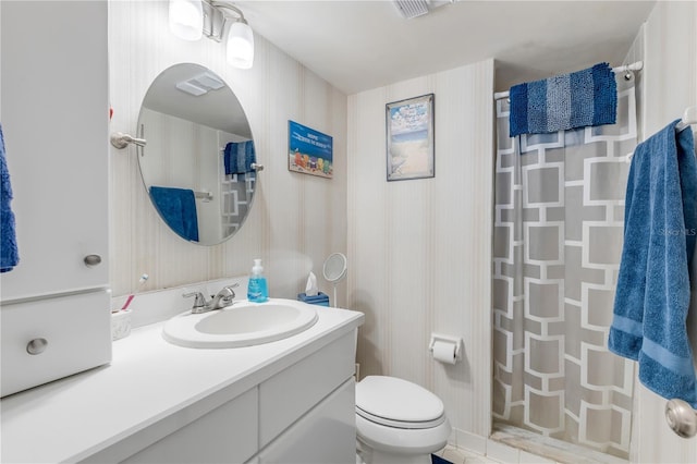 bathroom with vanity, toilet, and walk in shower