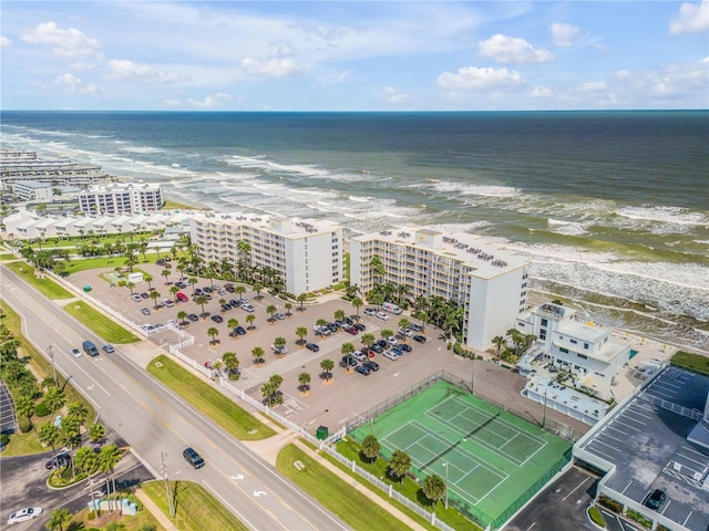 drone / aerial view featuring a beach view and a water view