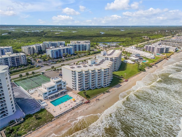 drone / aerial view with a water view and a view of the beach