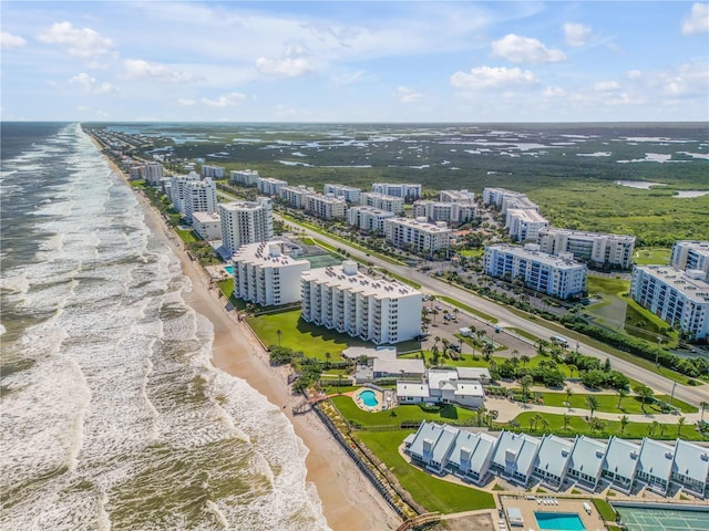 birds eye view of property featuring a water view and a view of the beach