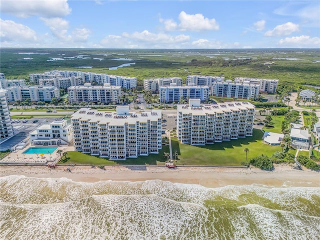 birds eye view of property featuring a water view and a view of the beach