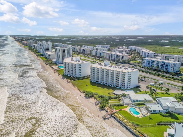 drone / aerial view with a water view and a beach view