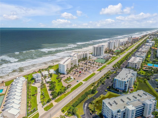 aerial view with a water view and a beach view