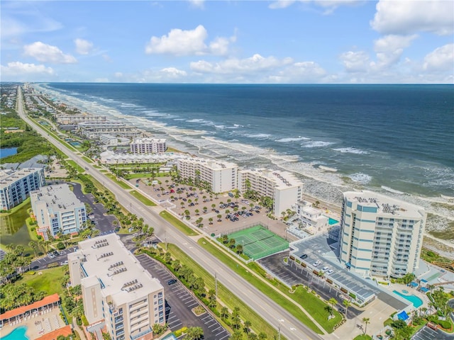 birds eye view of property featuring a water view and a beach view