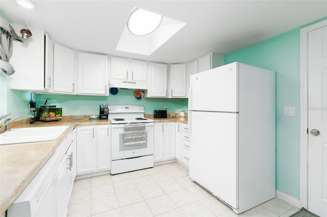 kitchen with sink, white appliances, a skylight, white cabinets, and light tile patterned flooring