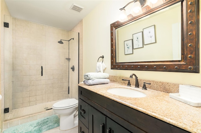 bathroom featuring tile patterned flooring, vanity, walk in shower, and toilet