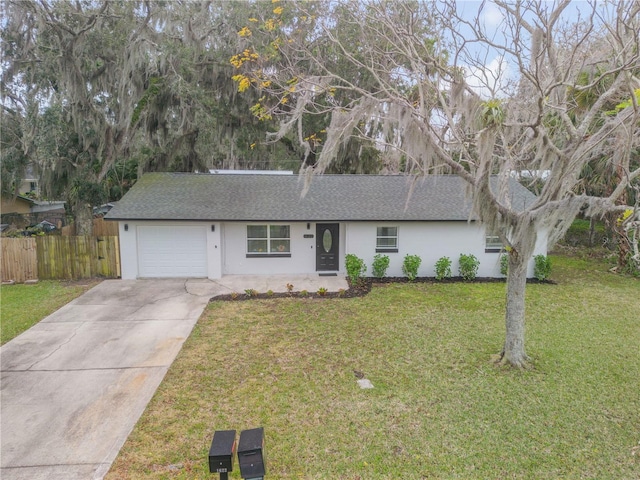 single story home featuring a garage and a front yard