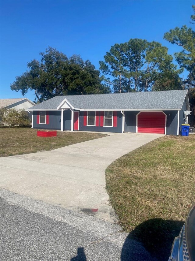 ranch-style house with a garage and a front yard