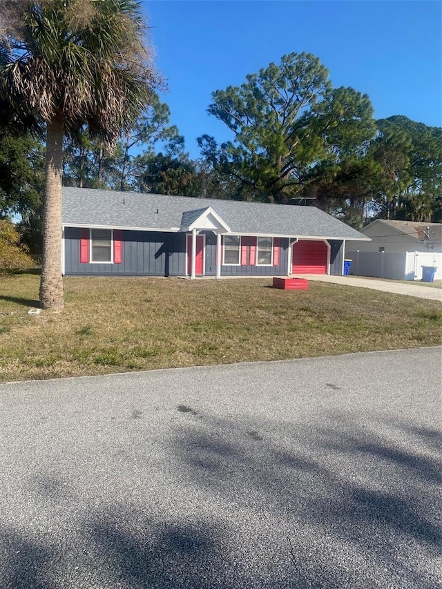 ranch-style home with a garage and a front yard