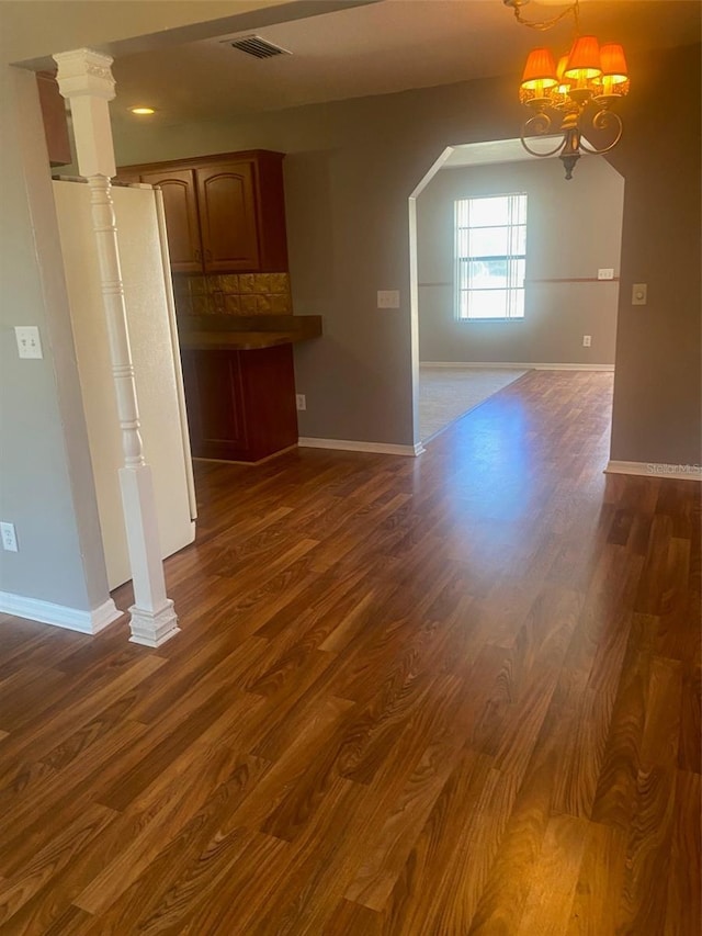 interior space featuring a notable chandelier and dark hardwood / wood-style floors