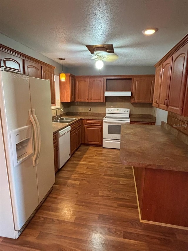 kitchen with sink, hanging light fixtures, white appliances, ceiling fan, and a textured ceiling