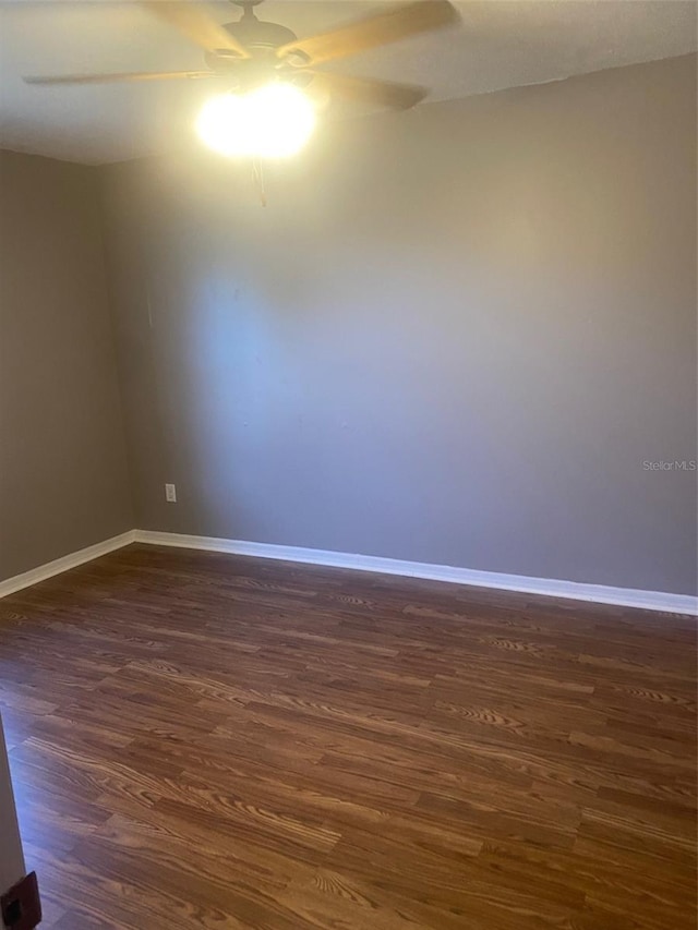 unfurnished room featuring dark hardwood / wood-style floors and ceiling fan