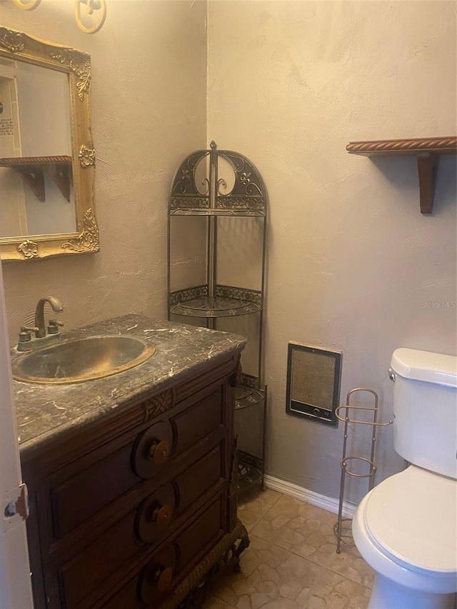 bathroom featuring vanity, tile patterned flooring, and toilet