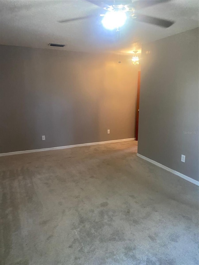 spare room with carpet floors and ceiling fan