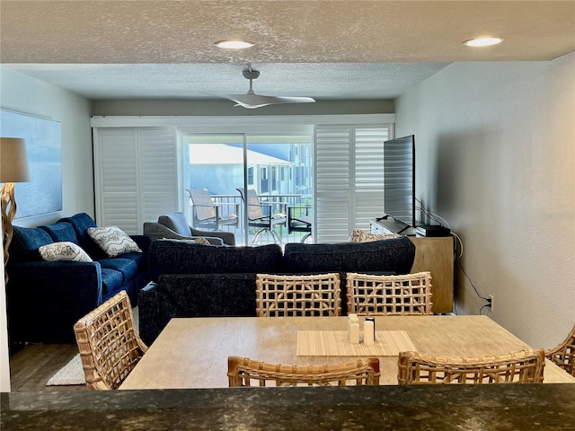 dining space featuring ceiling fan and a textured ceiling