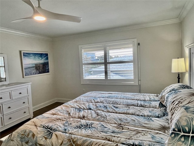 bedroom with ornamental molding, dark hardwood / wood-style flooring, and ceiling fan