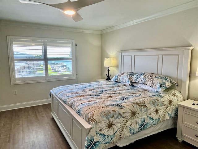 bedroom with crown molding, dark hardwood / wood-style floors, and ceiling fan