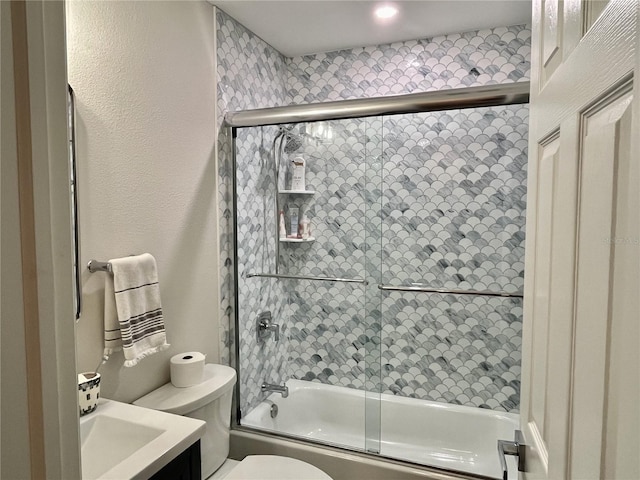 full bathroom with vanity, toilet, and combined bath / shower with glass door