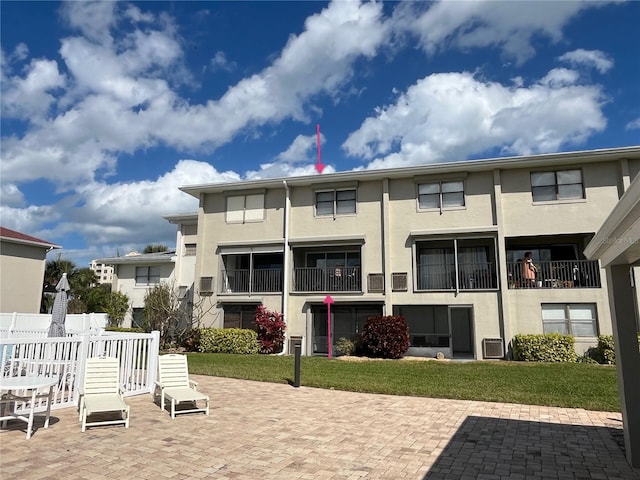 rear view of house featuring a lawn