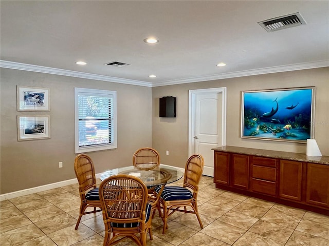 dining space featuring crown molding and light tile patterned floors