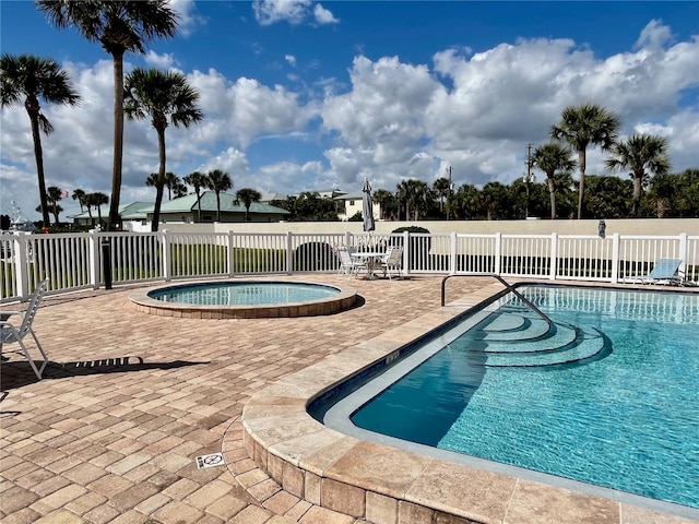 view of pool featuring a patio and a community hot tub