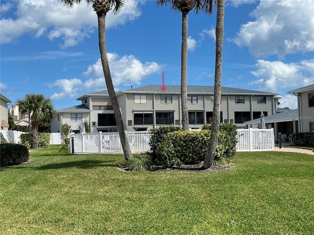 back of property featuring a lawn