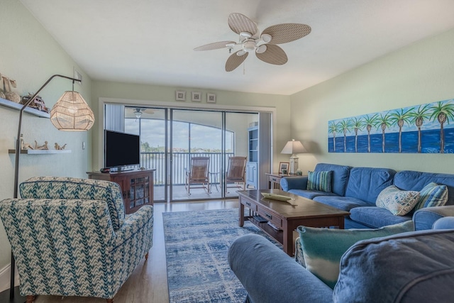 living room with wood-type flooring and ceiling fan