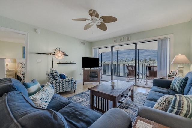 living room with ceiling fan and hardwood / wood-style floors