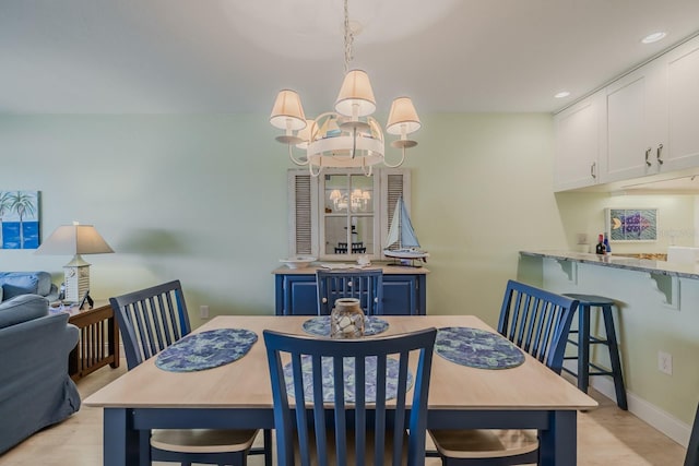 dining area featuring a chandelier and light hardwood / wood-style floors