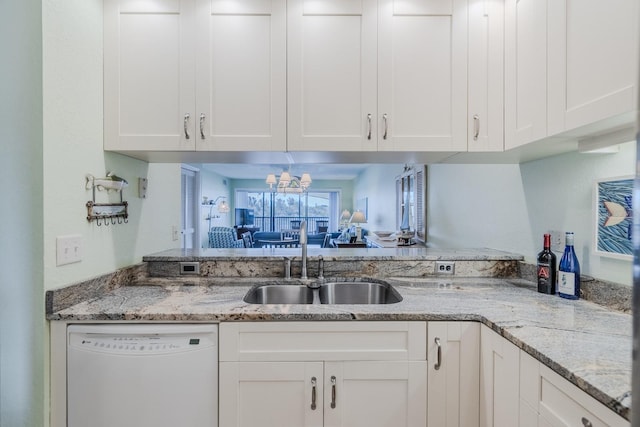 kitchen with white cabinetry, white dishwasher, light stone countertops, and sink