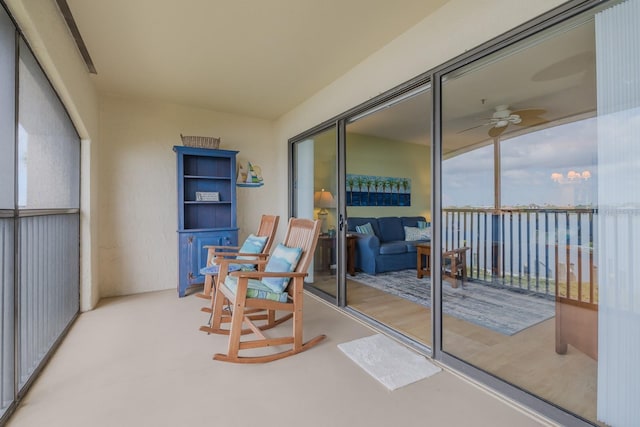 interior space with ceiling fan and a water view