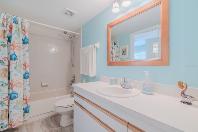 full bathroom with shower / tub combo, vanity, and toilet