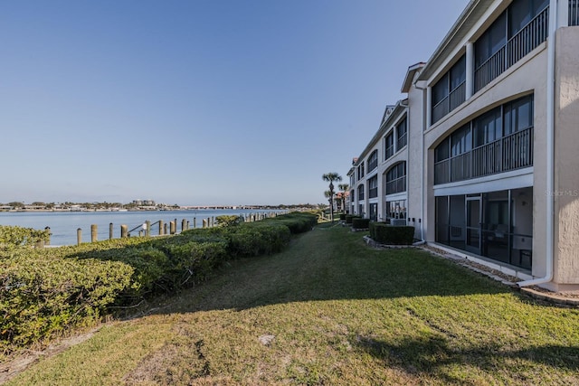 exterior space featuring a water view and a yard