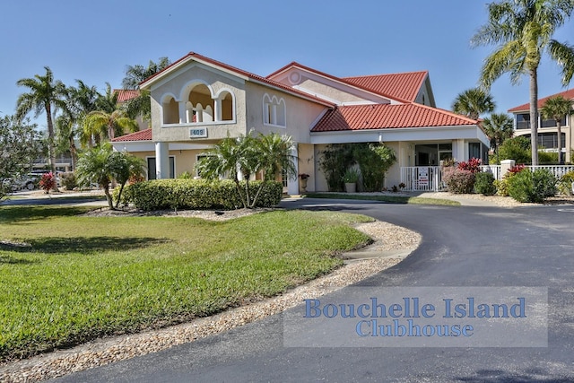 mediterranean / spanish-style house featuring a front yard