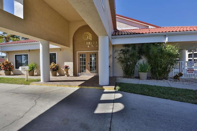 property entrance with a patio area and french doors