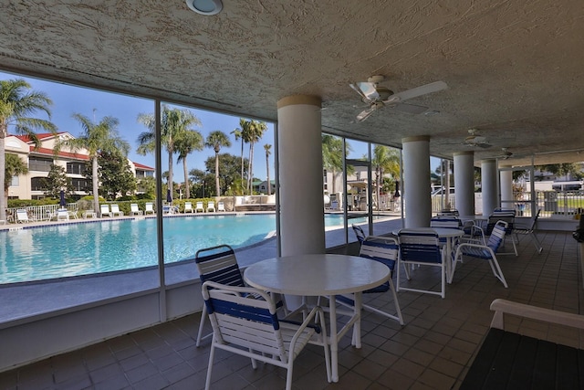 view of pool featuring ceiling fan and a patio