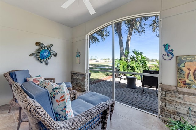 interior space with ceiling fan