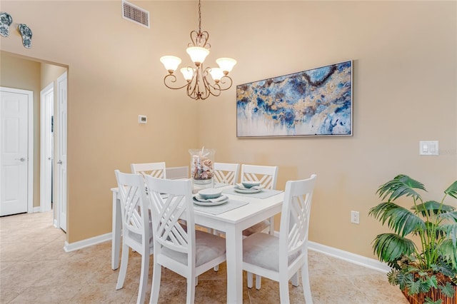 tiled dining room featuring a chandelier