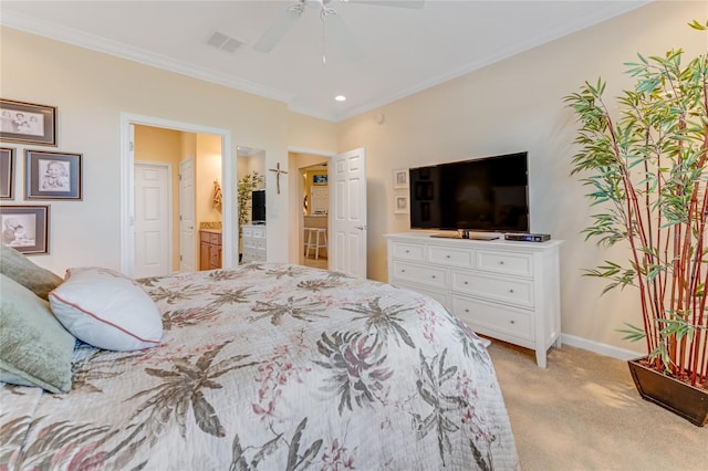 carpeted bedroom featuring crown molding, ensuite bath, and ceiling fan