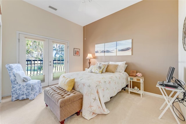 bedroom with access to outside, french doors, ceiling fan, and carpet