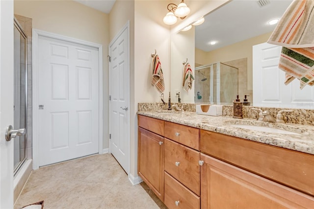 bathroom with vanity, tile patterned floors, and a shower with shower door