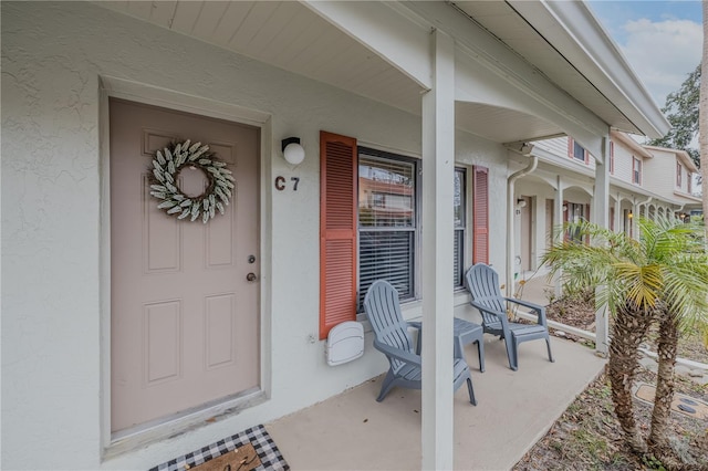 doorway to property featuring covered porch