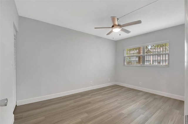 empty room with light hardwood / wood-style flooring and ceiling fan