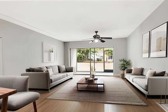 living room featuring hardwood / wood-style floors and ceiling fan