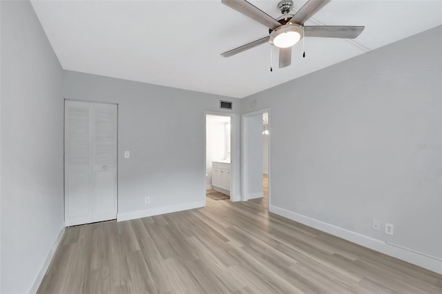 empty room with ceiling fan and light wood-type flooring