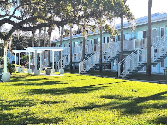 view of property's community with a lawn