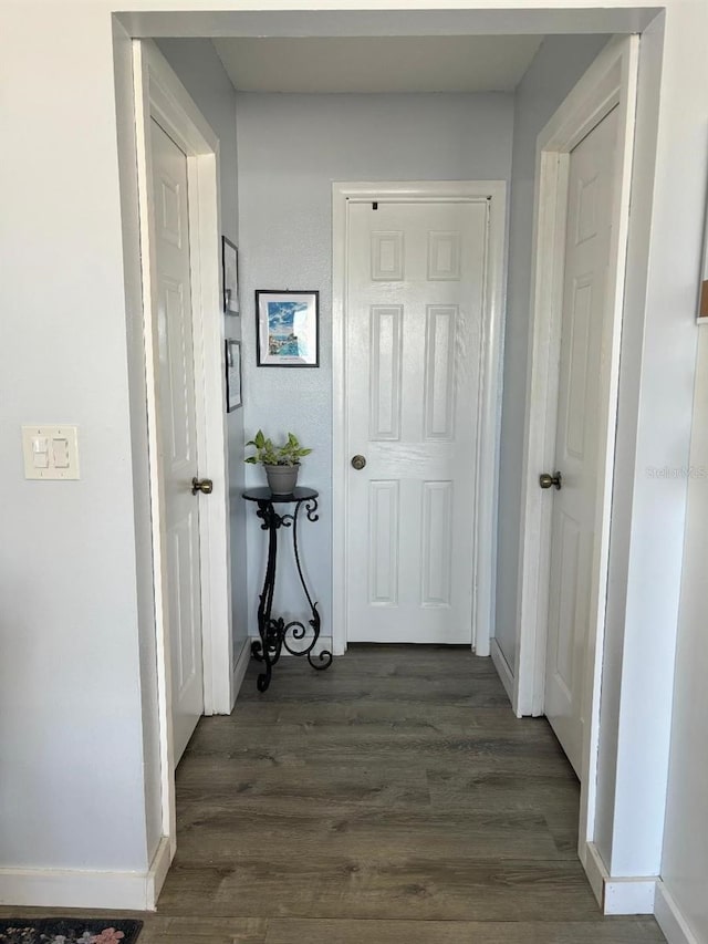 corridor with dark wood-type flooring