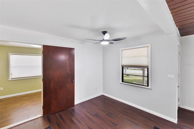 unfurnished bedroom featuring dark wood-type flooring and ceiling fan