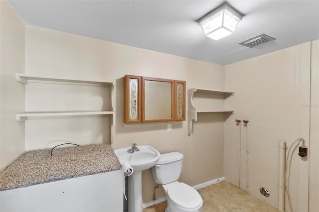 bathroom featuring toilet and sink