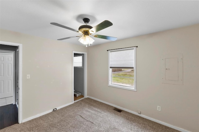 unfurnished bedroom featuring carpet, electric panel, and ceiling fan